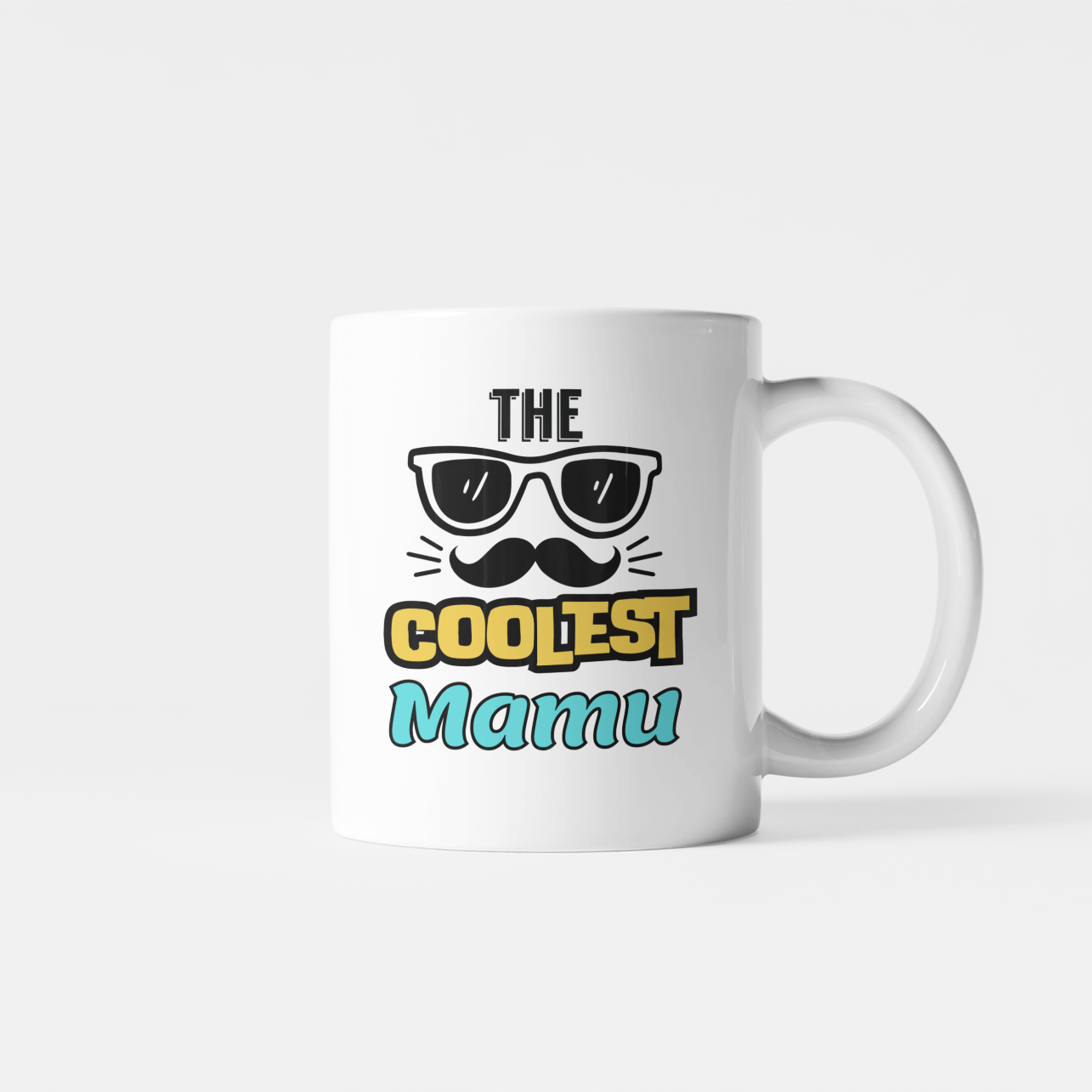 White The Coolest Mamu mug with sunglasses and moustache illustration, yellow “COOLEST” lettering and blue “Mamu” text