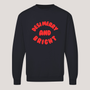 Dark navy unisex Desi Merry & Bright Christmas sweatshirt featuring bold red 'Desi Merry and Bright' lettering arranged in a playful curved design on the front.