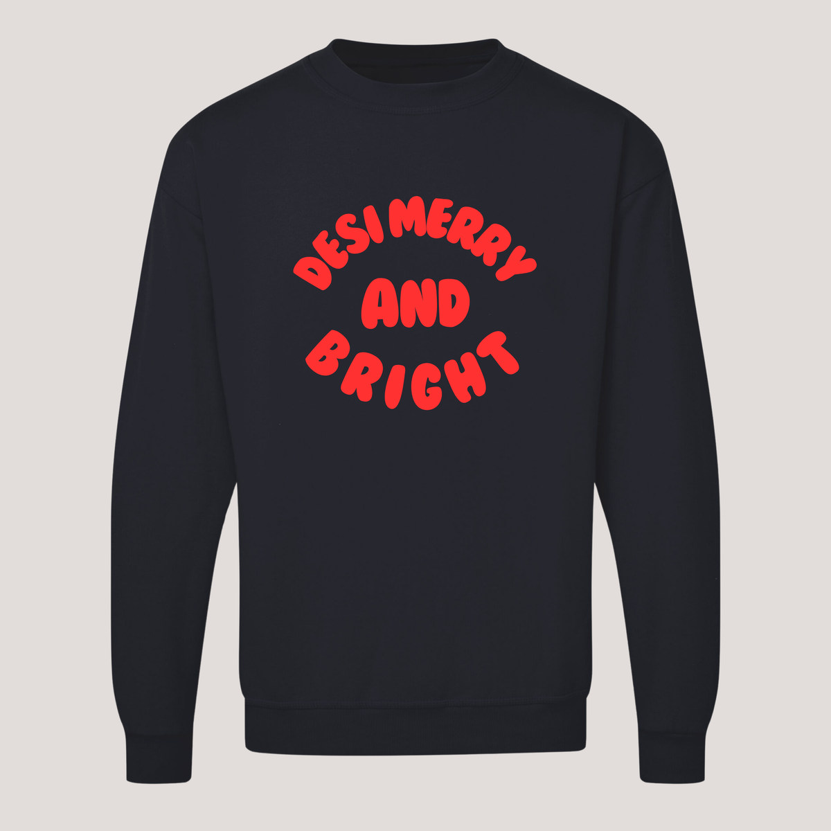 Dark navy unisex Desi Merry & Bright Christmas sweatshirt featuring bold red 'Desi Merry and Bright' lettering arranged in a playful curved design on the front.