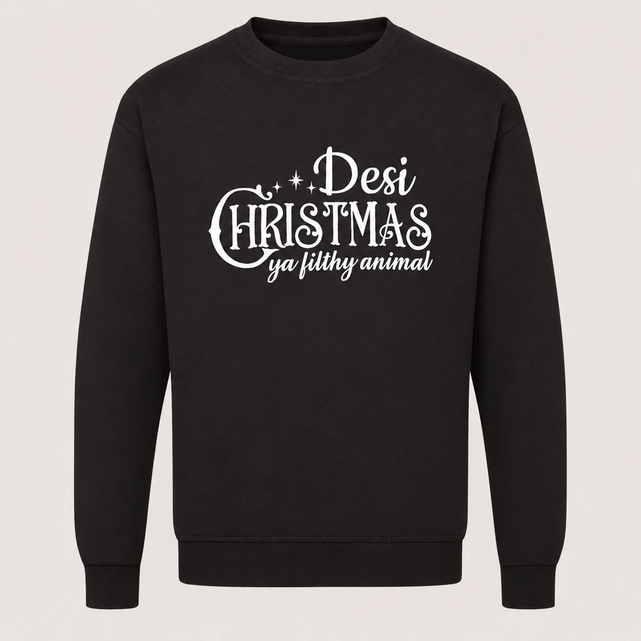 Black unisex Desi Christmas Ya Filthy Animal sweatshirt featuring decorative white Christmas typography and the cheeky festive slogan inspired by Home Alone.