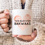 White mug with a rose gold leopard-print heart and the words “Too Busy for Bakwaas” in bold black lettering