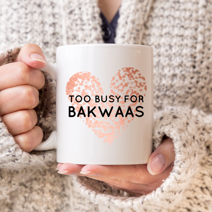 White mug with a rose gold leopard-print heart and the words “Too Busy for Bakwaas” in bold black lettering