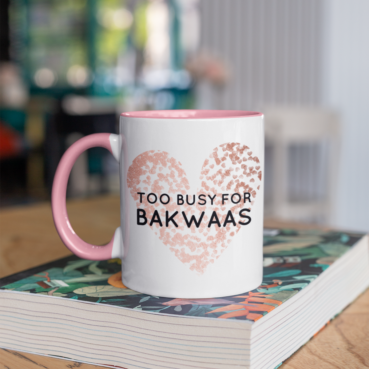 Pink mug with a rose gold leopard-print heart and the words “Too Busy for Bakwaas” in bold black lettering
