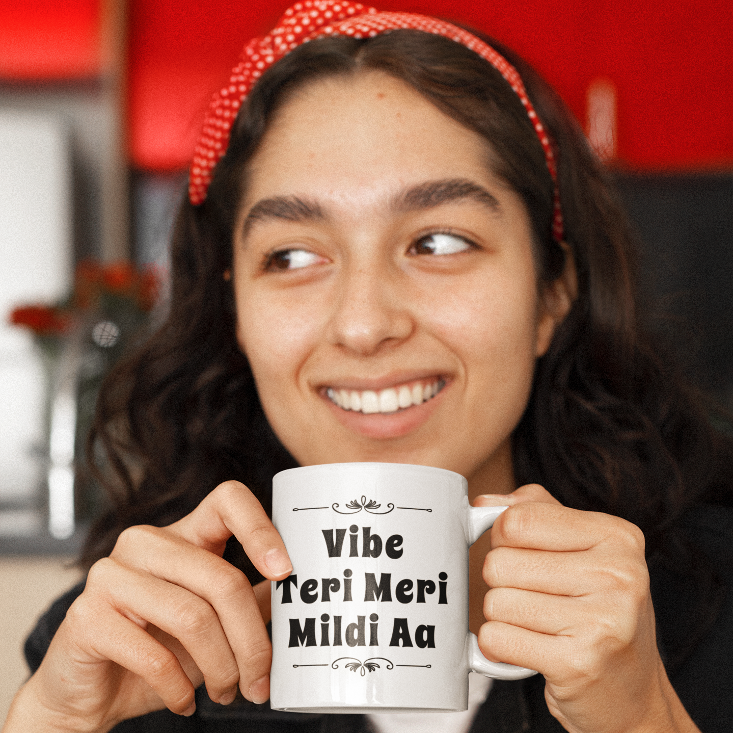 Smiling woman holding a white Diljit Dosanjh mug with bold black “Vibe Teri Meri Mildi Aa” lettering and decorative flourishes